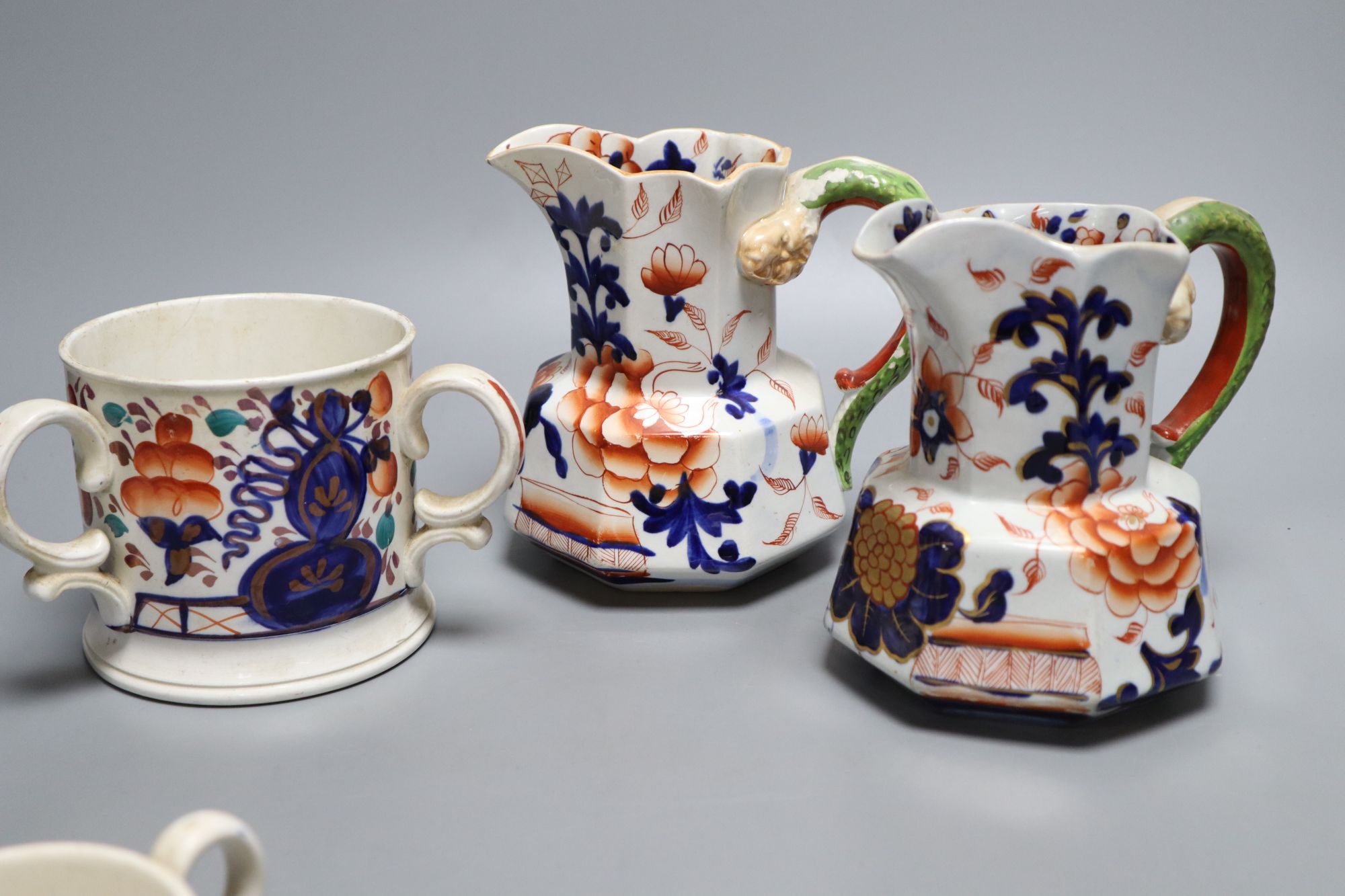 Eight pieces of Ironstone china including two jugs and a three handled cider mug